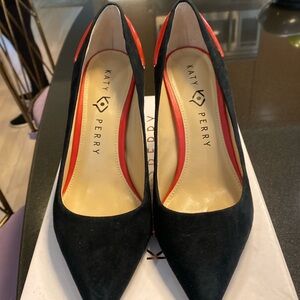 Black suede heels with red patent leather lips on back. Never worn.